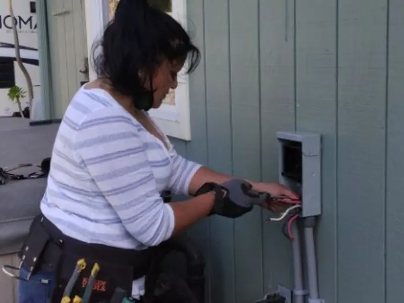 Licensed electrician wiring an exterior subpanel in Perryton